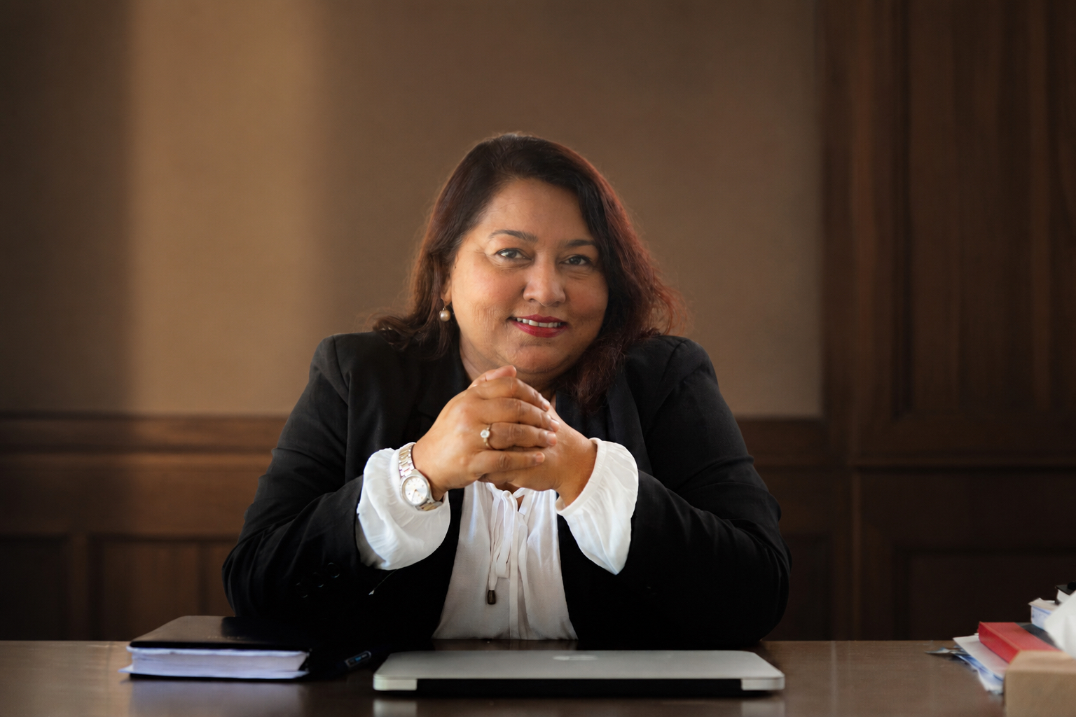 Me Mokshda Pertaub seated at her desk